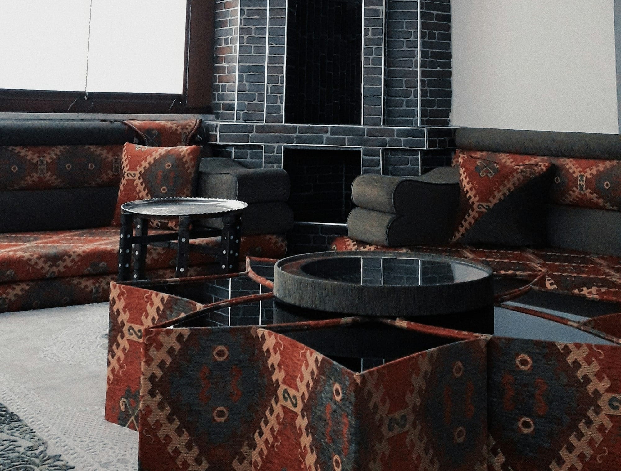 black fireplace near brown couch