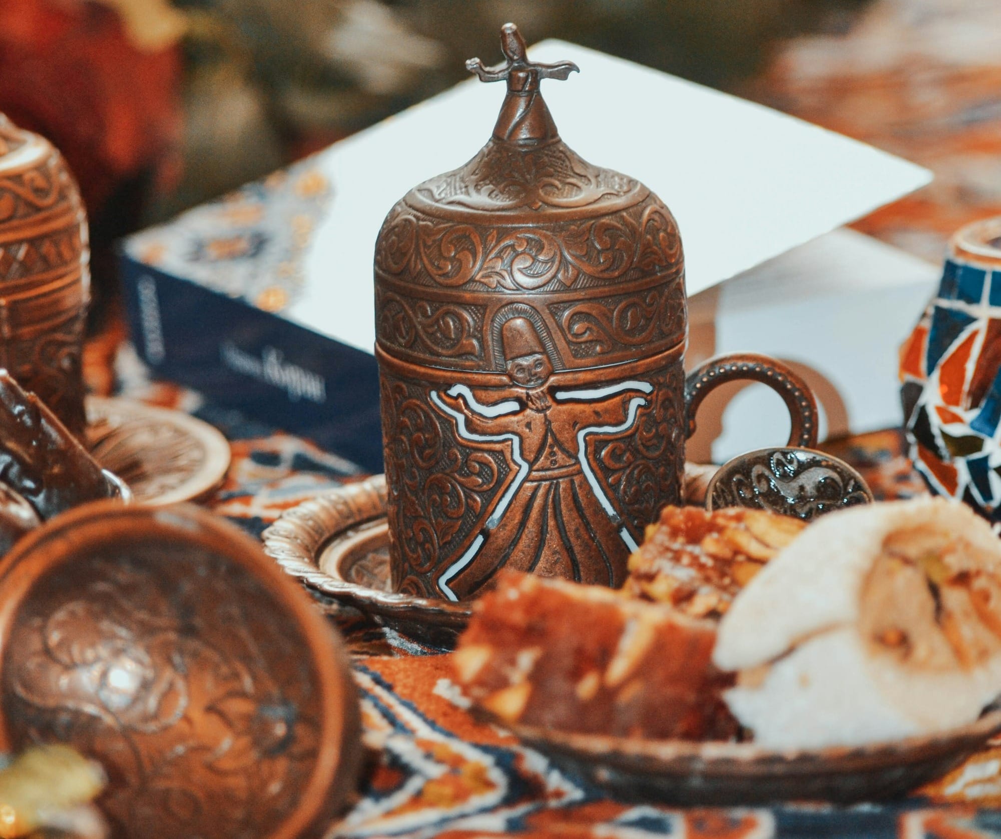 a table topped with a plate of food and a vase