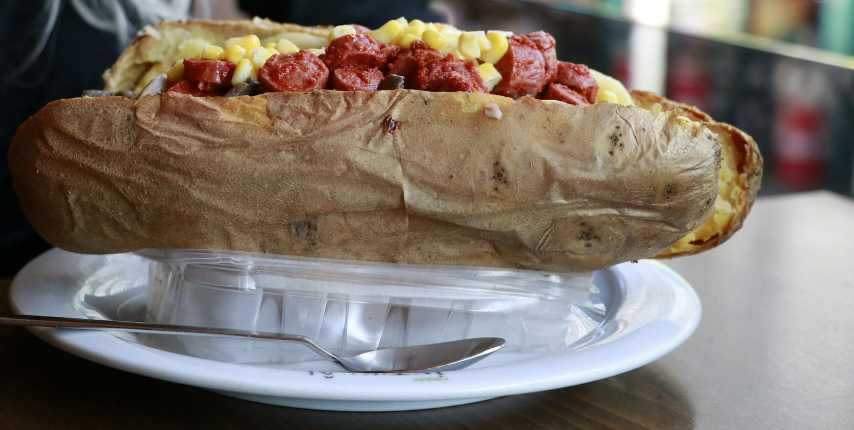 a person sitting at a table with a plate of food